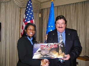 In November, Makeva Flowers (l), BOSH Global Services, receives the chapter's AFCEAN of the Month Award and an Air Force Monopoly set from Kelley.